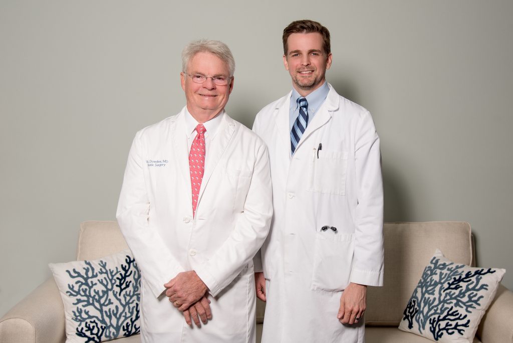 Dr. Dowden and Dr. Nimtz wearing white lab coats standing together