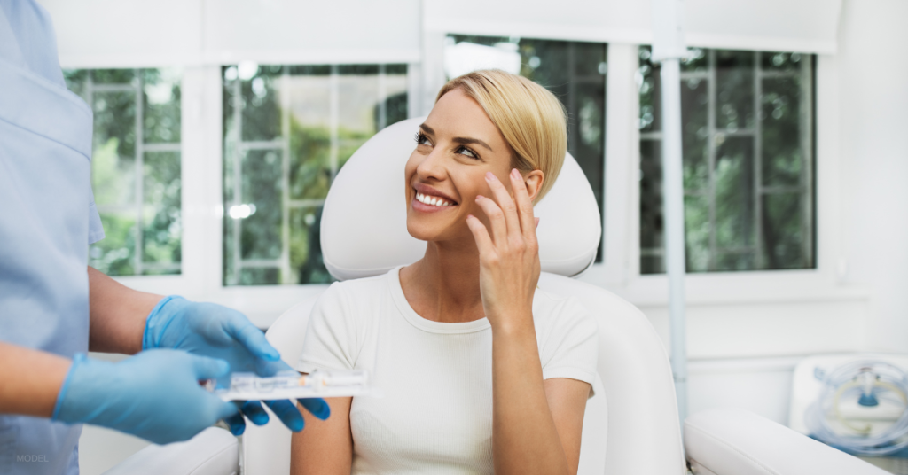 Women smiling after dermal filler treatment (model)