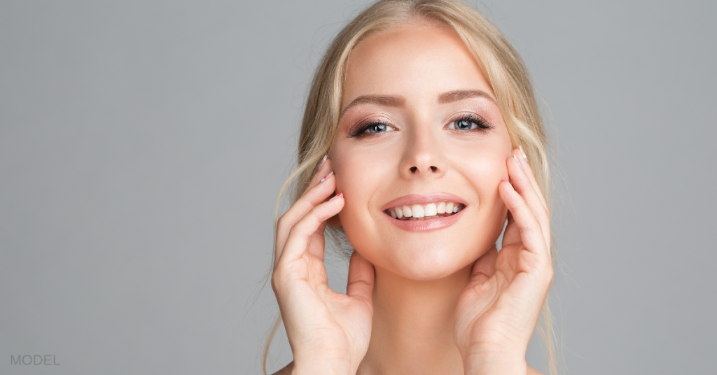 Cheerful Smiling Young Woman Massaging Face Cheek Bones (model)